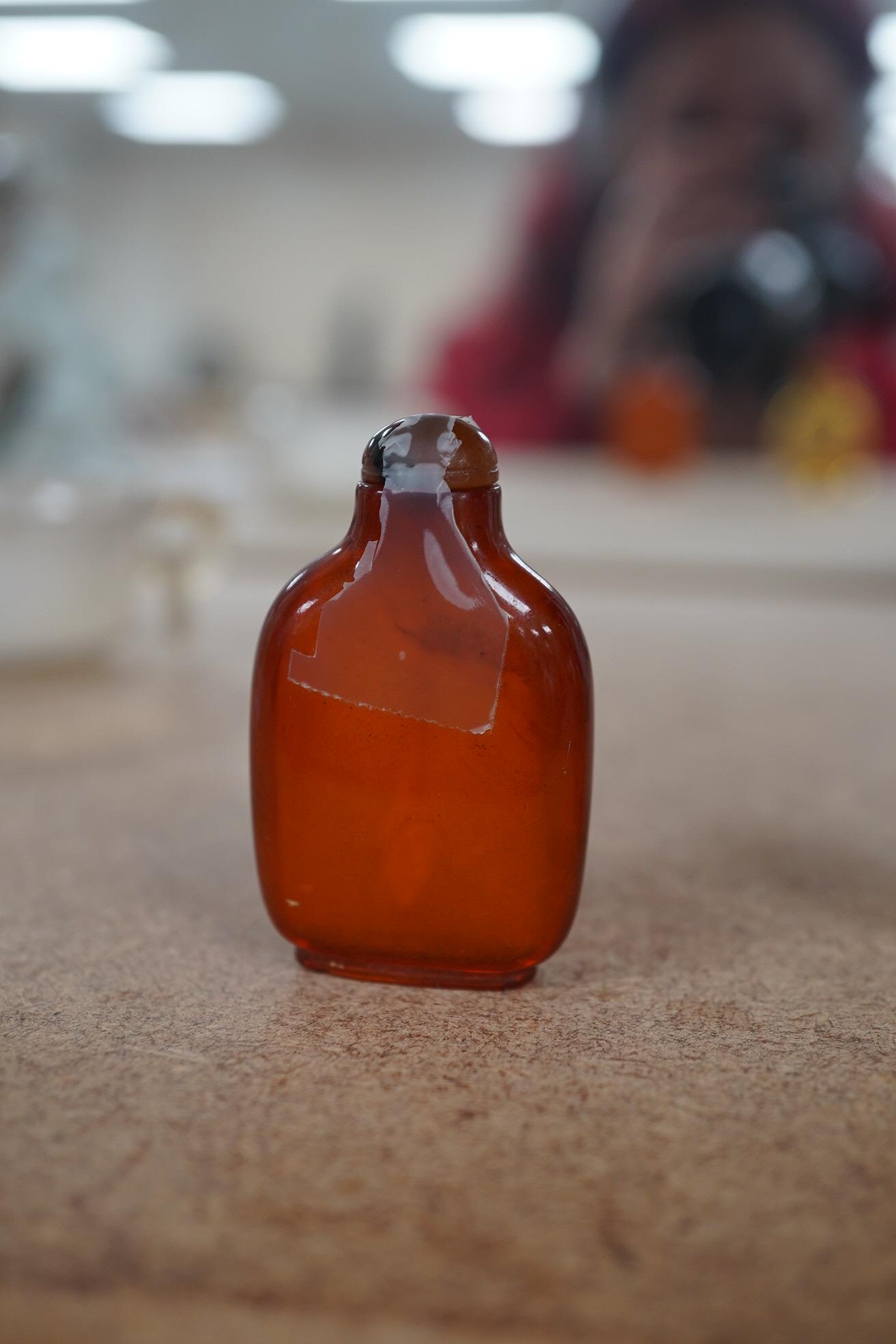 Two Chinese snuff bottles, amber and orange glass, and a similar bowenite bowl, 8cm. Condition - fair